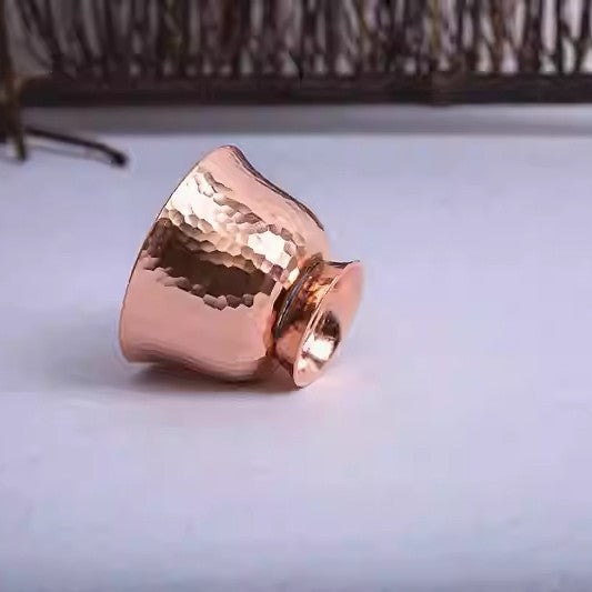 Single copper-colored hammered cup