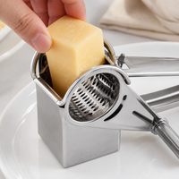 Manual metal cheese grater with two drums