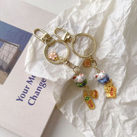 Lucky Cat Ceramic Keychain with Fan Design for Car Keys, Bags, and Accessories