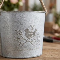 Distressed White Hanging Flower Pot Bird Motif Iron Flower Pot Rope Handle Metal Bucket Planter Printed Text
