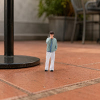 Thoughtful Pose Miniature Figurine Curly-Haired Hand-Painted Figurine
